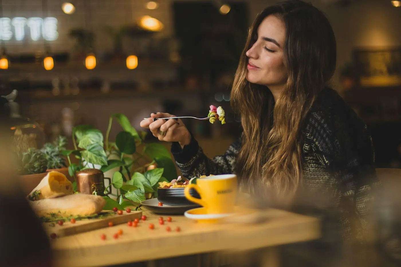 People eating together and smiling at a restaurant table